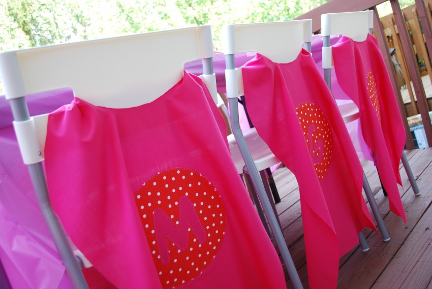 Girl's superhero birthday party - monogrammed capes on chair backs