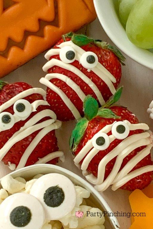 Party Pinching Halloween Charcuterie Board - mummy strawberries